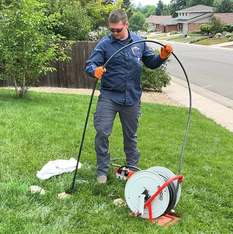 Bell technician performing drain cleaning in Denver