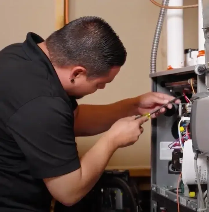 technician repairing furnace in Denver, co