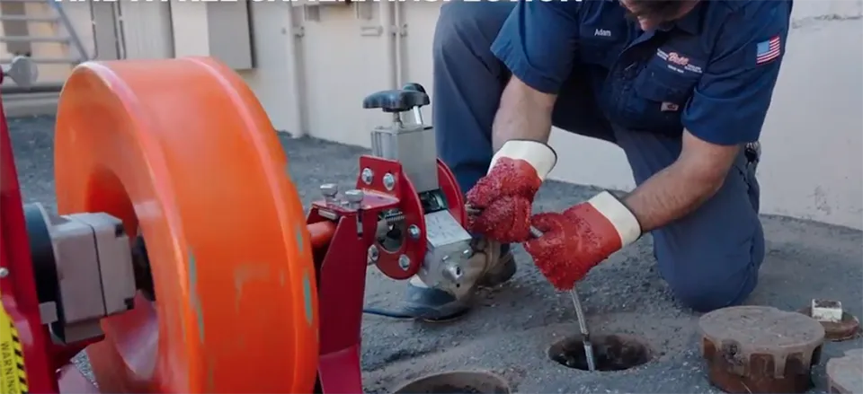 Technician snaking drain