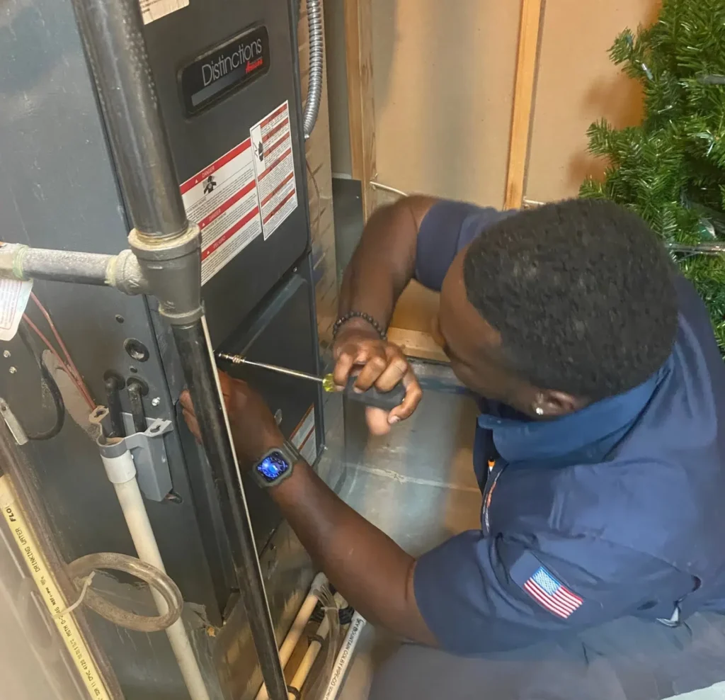 Technician repairing furnace