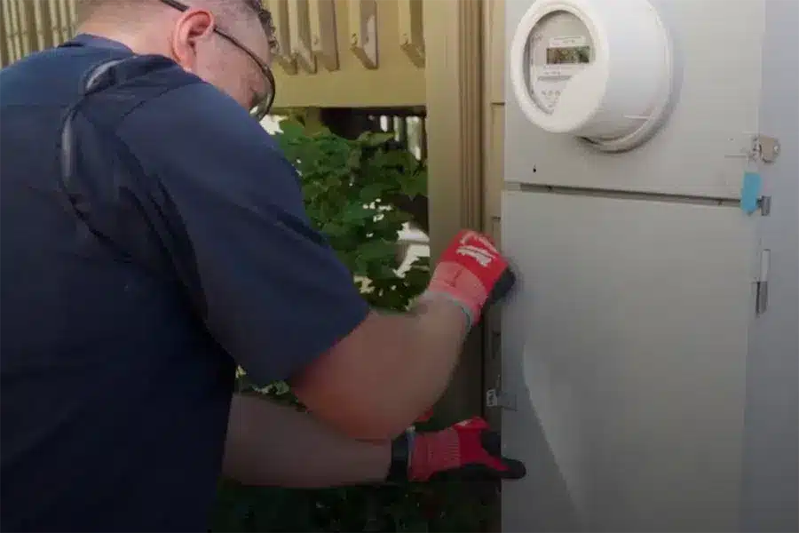 Technician servicing electrical panel in Denver, CO.