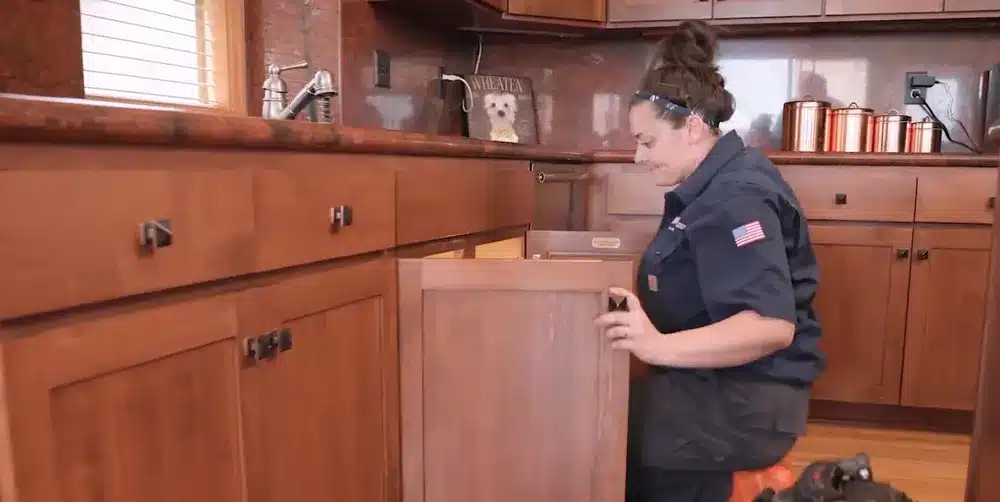 Technician looking at plumbing in Denver, CO