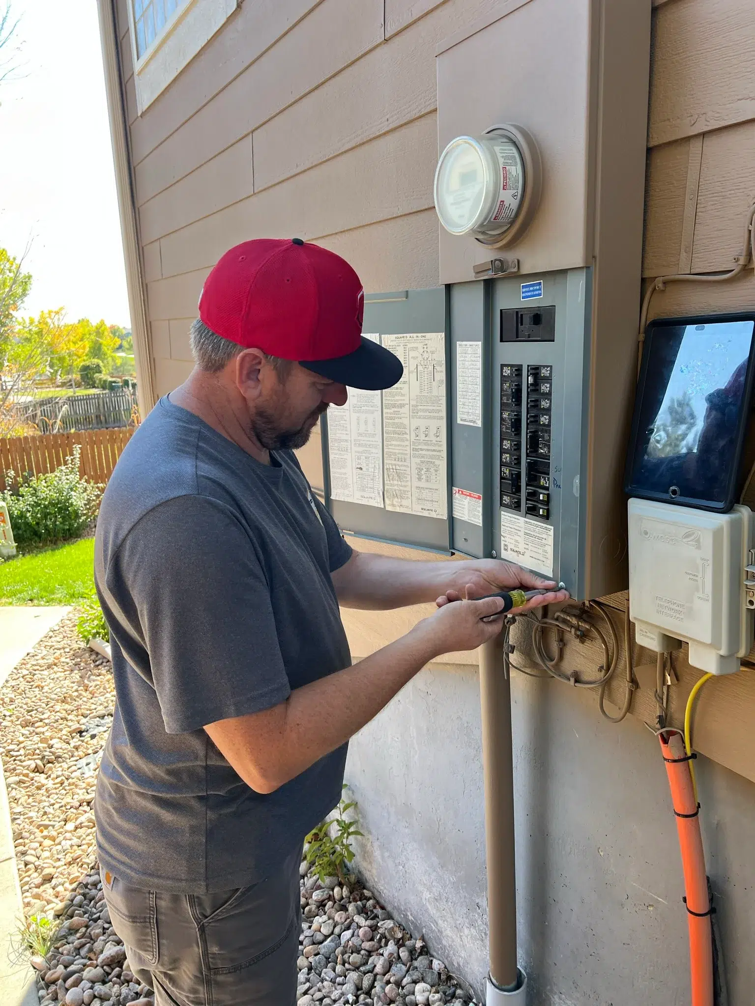 Electrician installing electrical panel in Denver