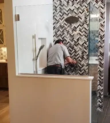 Technician repairing shower in Denver